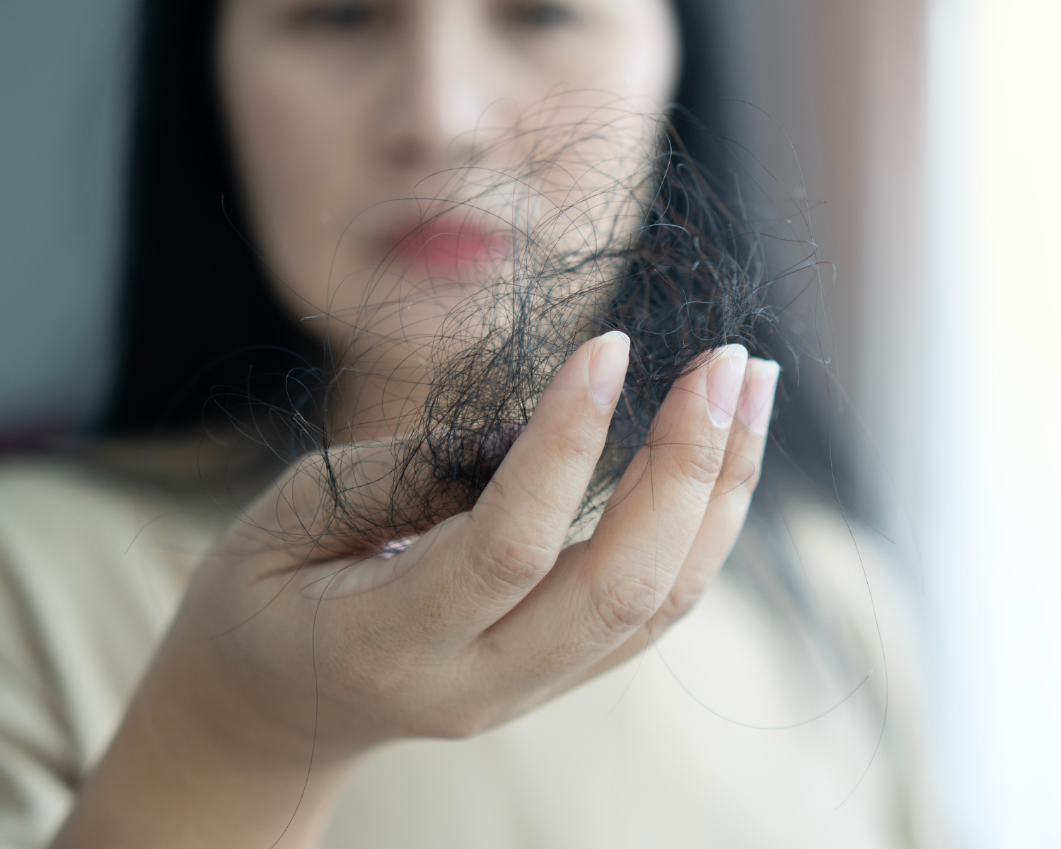 Menopausal hair loss, women holding hair in her handnd